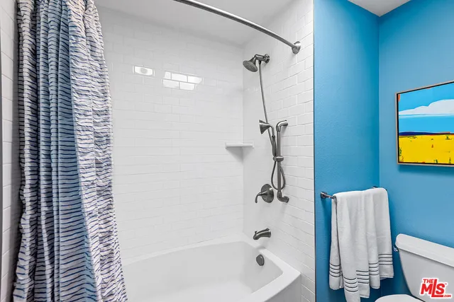 a bath room with a bath tub and a shower