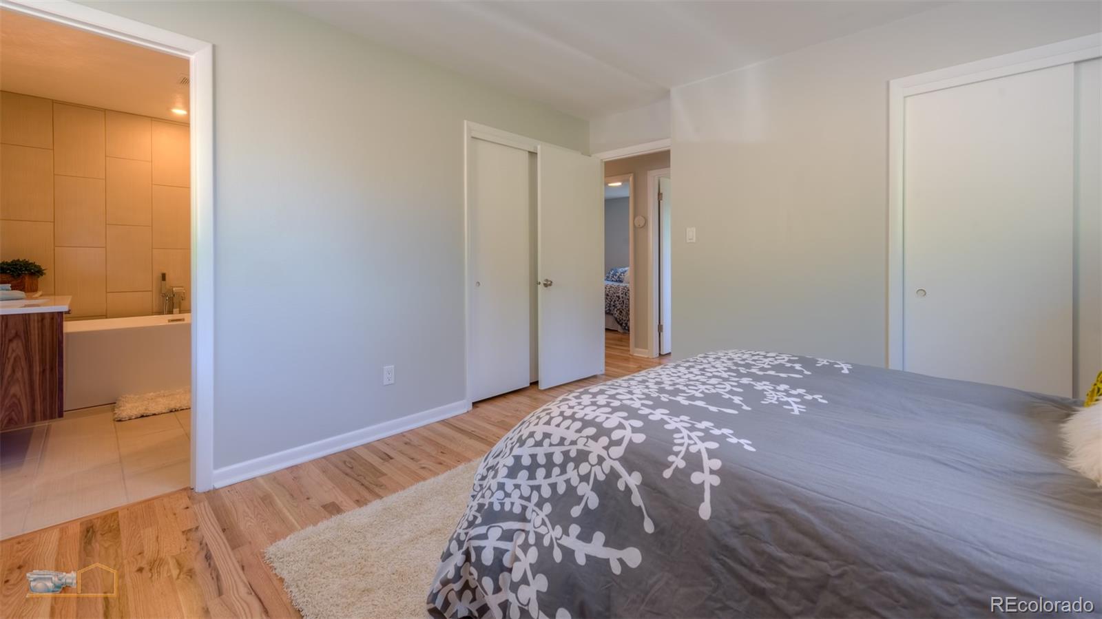 6724 Olde Stage Road Boulder, CO 80302 - Photo 8 of 30 a bedroom with a bed and wooden floor