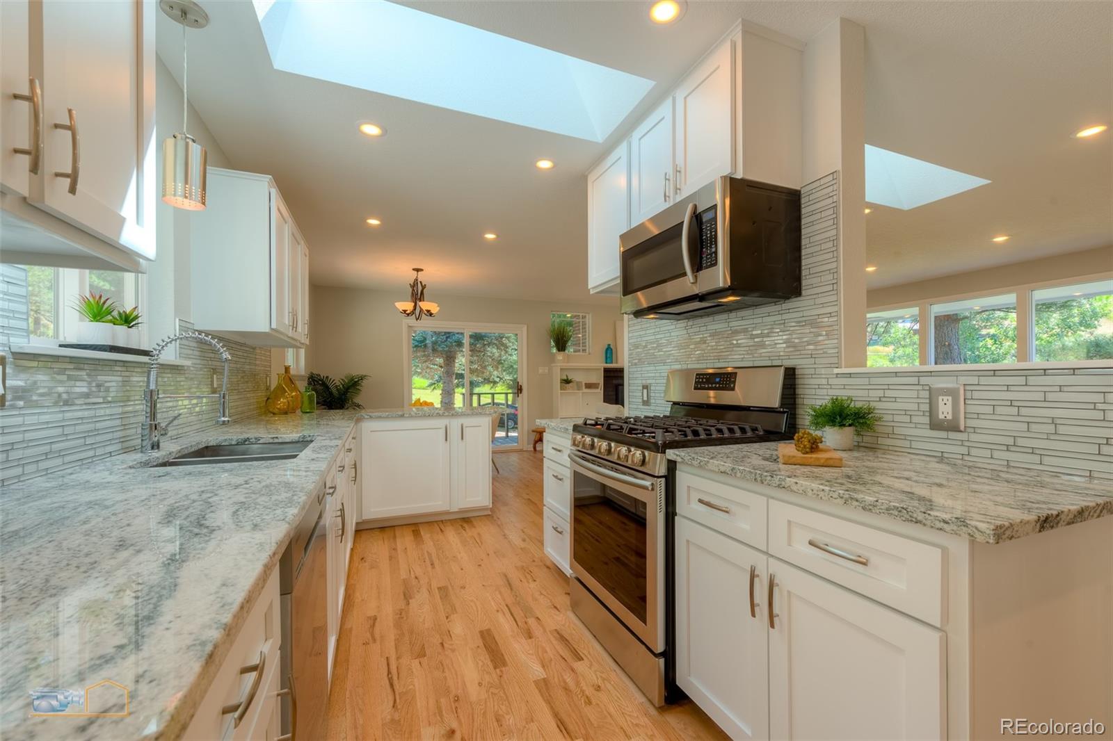 6724 Olde Stage Road Boulder, CO 80302 - Photo 9 of 30 a kitchen with stainless steel appliances granite countertop a sink a stove top oven a counter space and cabinets
