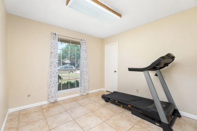 a room with gym equipment and a window