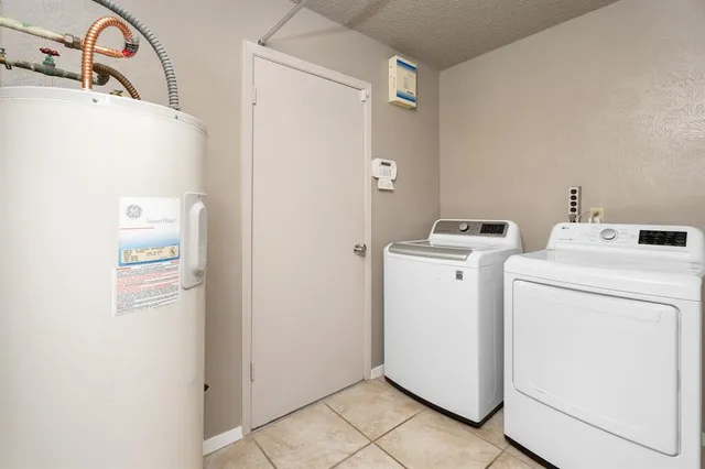 a view of a house with a backyard and a tree