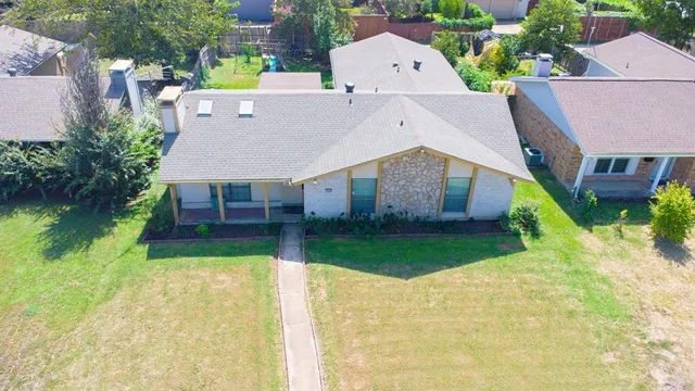 an aerial view of a house with a yard