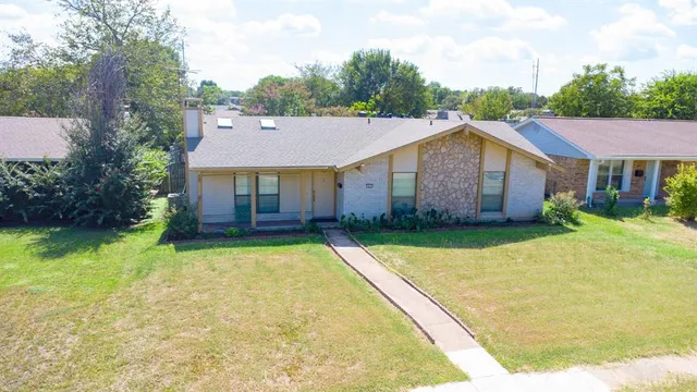 an aerial view of a house with a yard and trees