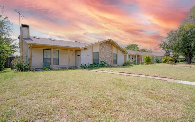 a front view of house with yard and trees
