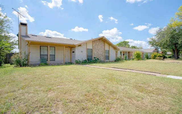 a front view of house with yard and trees