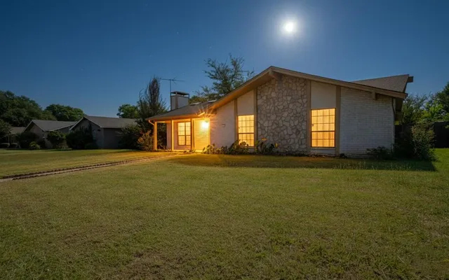 a front view of house and yard with green space