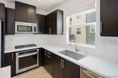 a kitchen with a sink stove and microwave