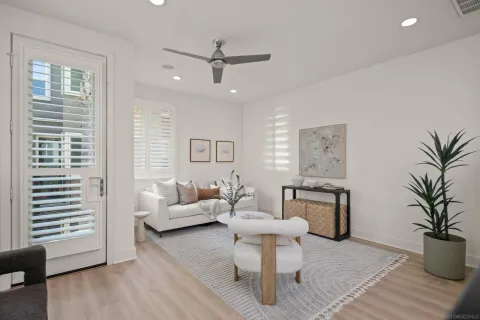 a living room with furniture a window and a potted plant