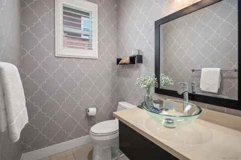 a bathroom with a sink a toilet and a mirror