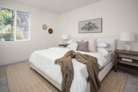 a bedroom with bed and a window