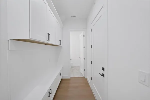 a view of a hallway with white walls