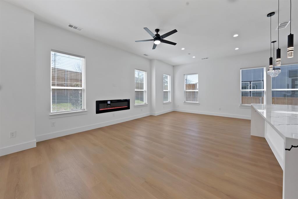 302 East 7th Street Dallas, TX 75203 - Photo 19 of 30 a view of an empty room with a window and wooden floor