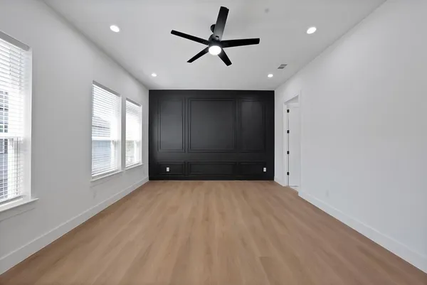a view of a livingroom with a ceiling fan and window