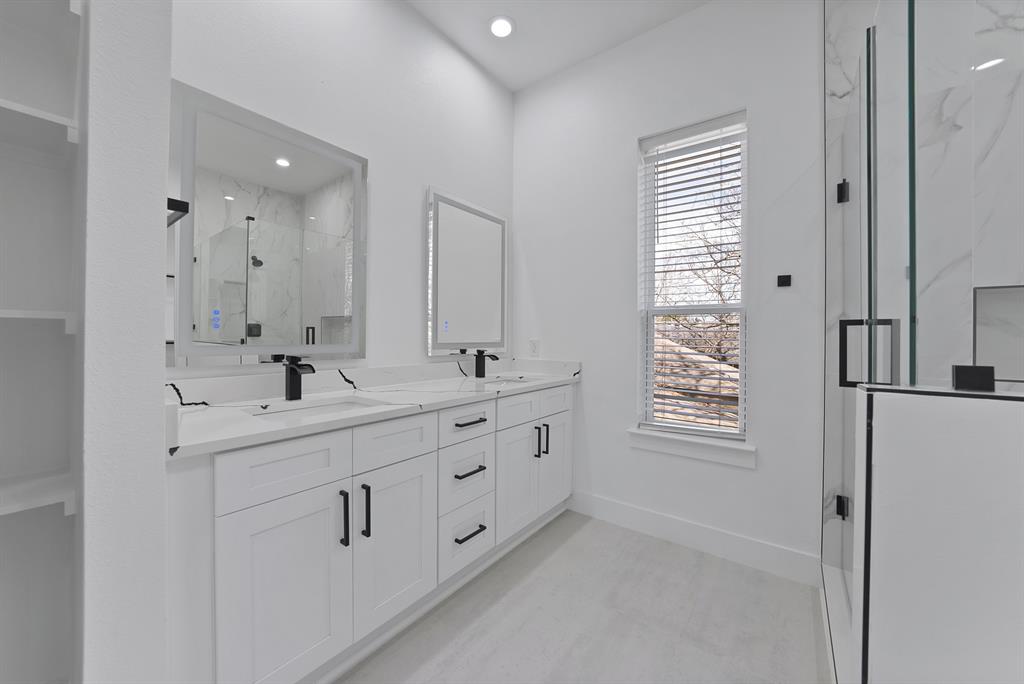 302 East 7th Street Dallas, TX 75203 - Photo 27 of 30 a bathroom with double vanity sink a window and a mirror