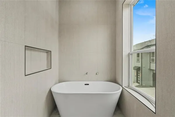 a white bath tub sitting next to a white sink