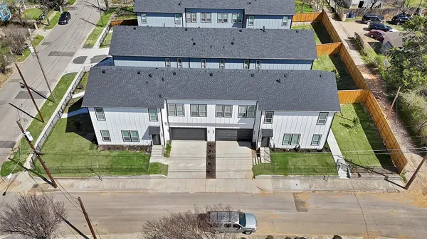 an aerial view of a house with a yard