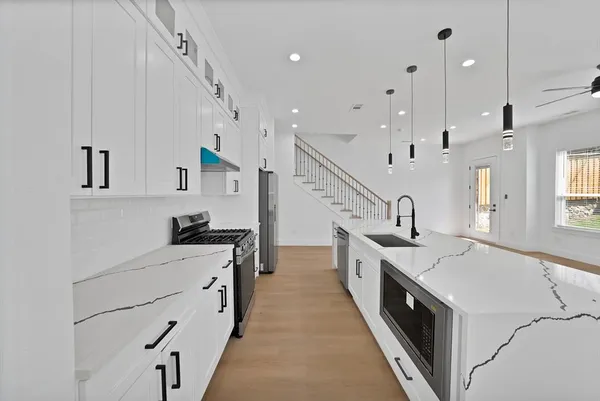 a large white kitchen with lots of counter space