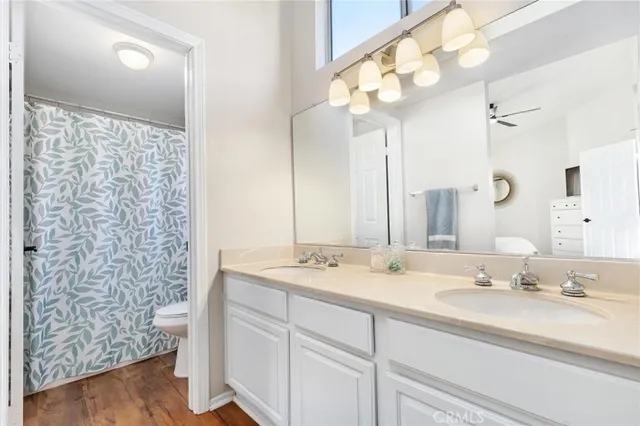 a bathroom with a double vanity sink mirror and shower