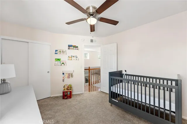 a bedroom with bed and a chandelier
