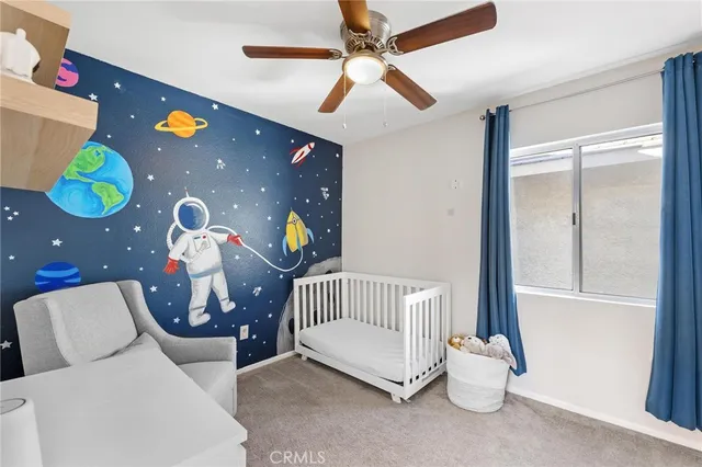 a living room with furniture and a ceiling fan