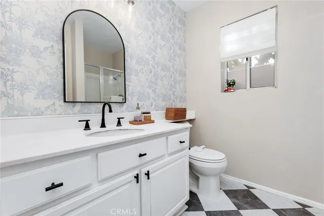 a bathroom with a glass shower door and a mirror
