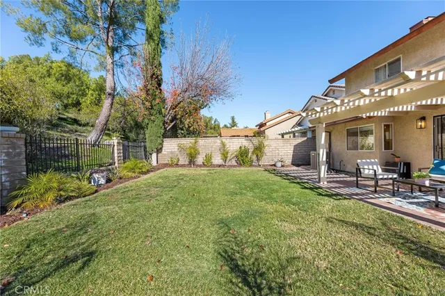 a view of a house with backyard and sitting area
