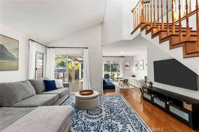 a living room with furniture a rug and a flat screen tv