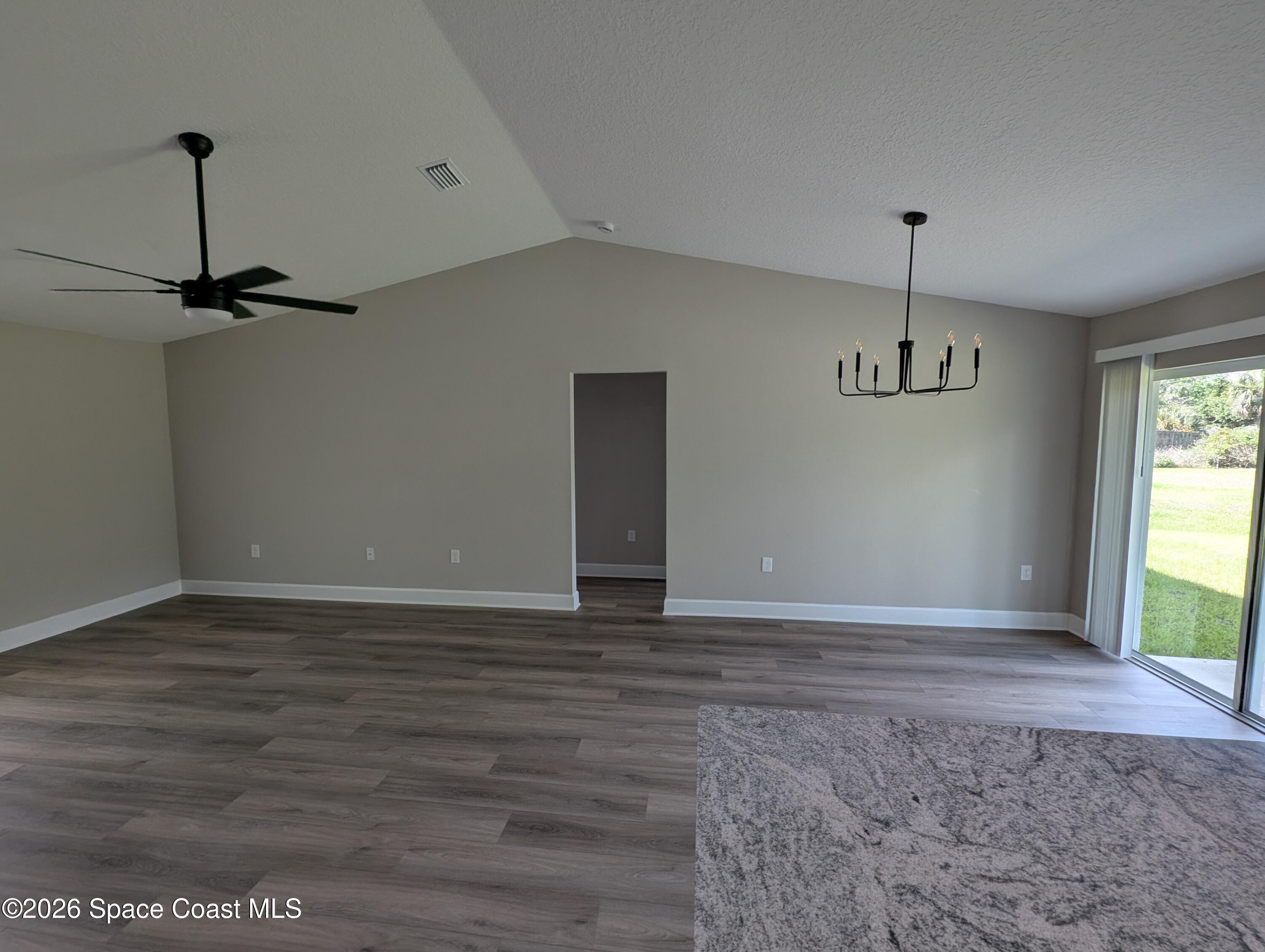 1356 Torgerson Road Southeast Palm Bay, FL 32909 - Photo 19 of 46 Living dining rooms with volume ceiling