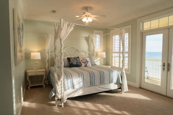 a bedroom with a bed and painting on the wall