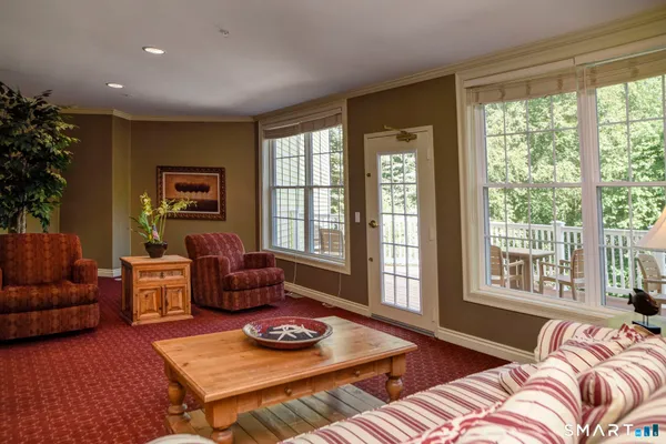 a bedroom with furniture and a large window