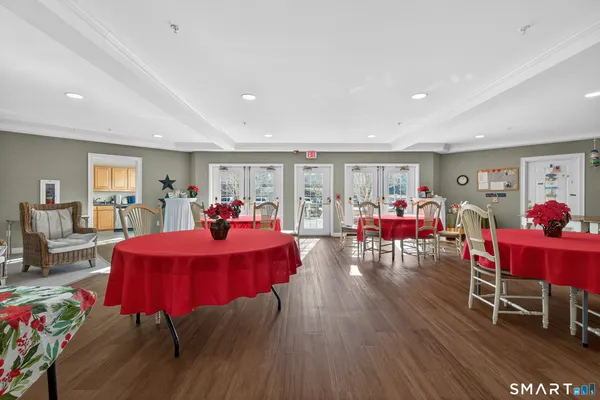a view of a dining room with furniture and wooden floor