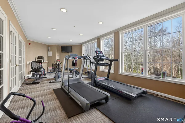 a room with gym equipment and large mirror