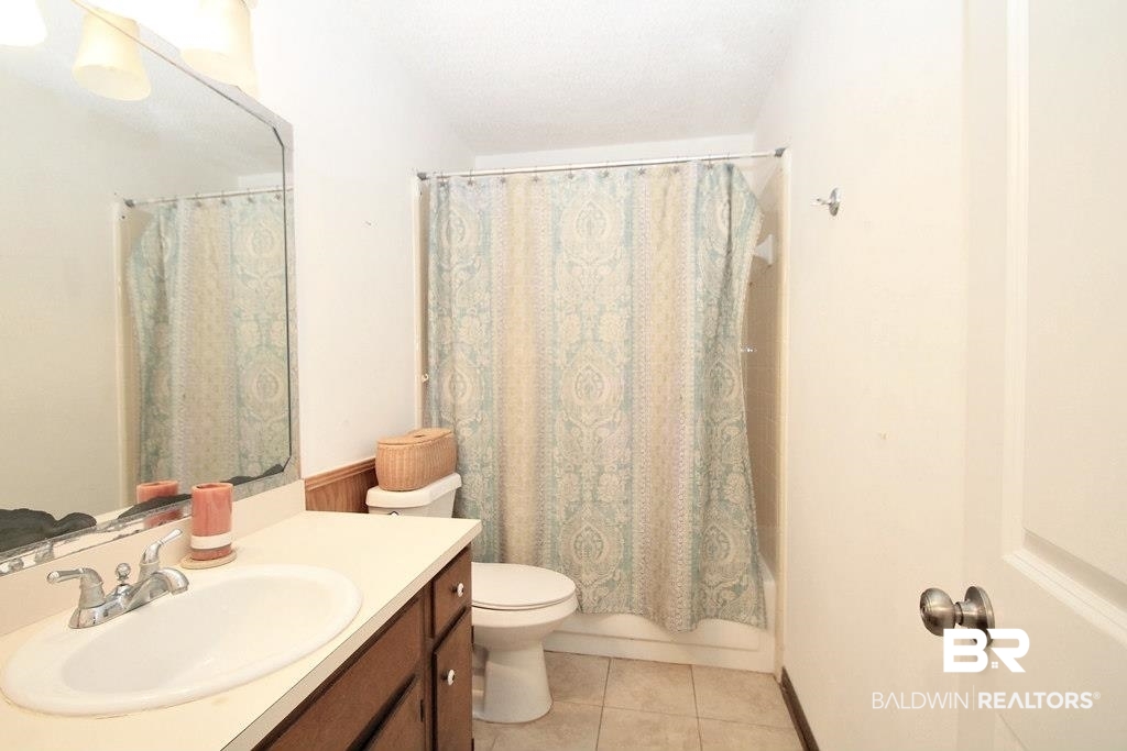 205 Montclair Loop Daphne, AL 36526 - Photo 12 of 19 Full bathroom featuring tile patterned flooring, vanity, shower / tub combo, and toilet