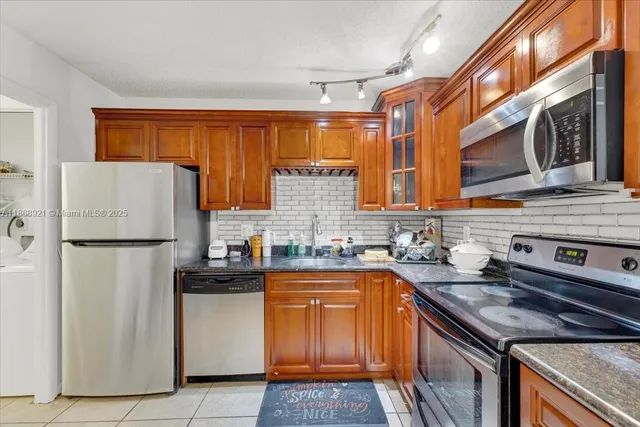 a kitchen with a sink stove and refrigerator