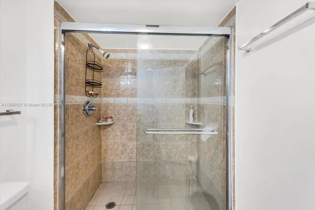 a bathroom with a glass door shower