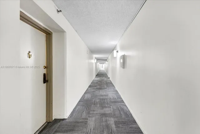 a view of a hallway with wooden floor and closet