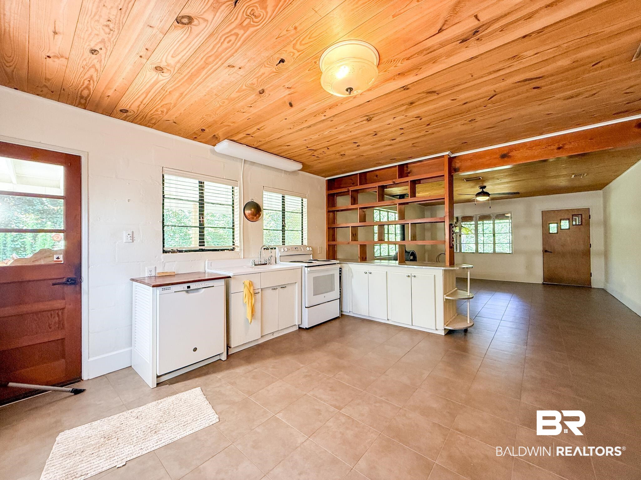 18711 Keller Road Foley, AL 36535 - Photo 10 of 38 Kitchen area featuring a wood-finish ceiling, tiled flooring, white cabinetry, integrated shelving, and white appliances