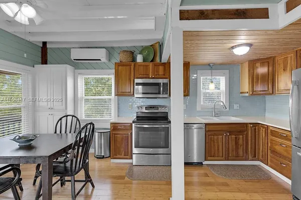 a view of a dining room with furniture window and wooden floor