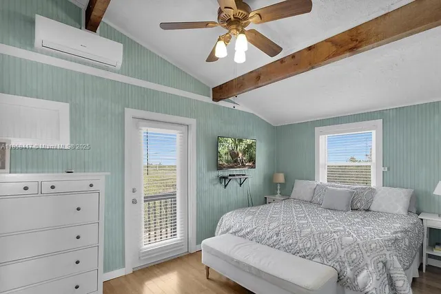 a bedroom with a large bed and a window