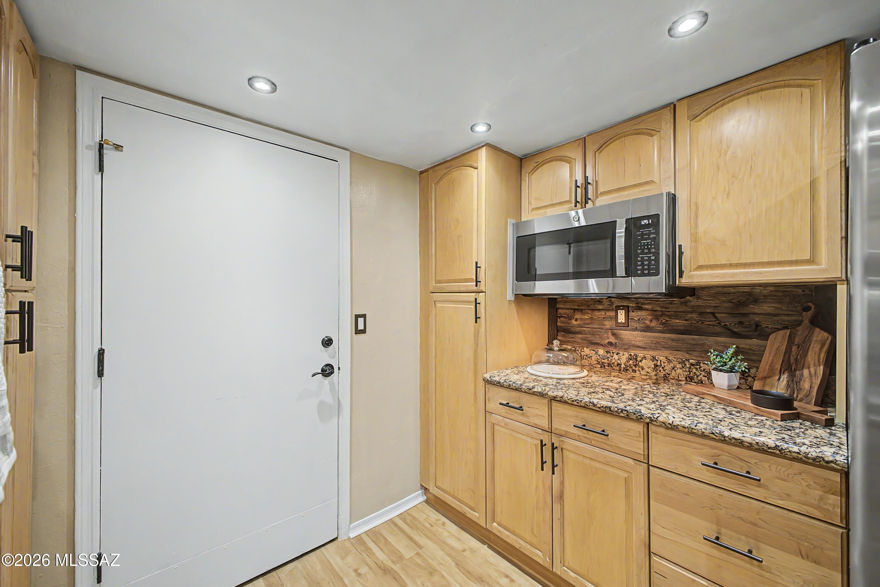 3781 East Edison Street Tucson, AZ 85716 - Photo 11 of 28 a kitchen with stainless steel appliances granite countertop a refrigerator and a microwave