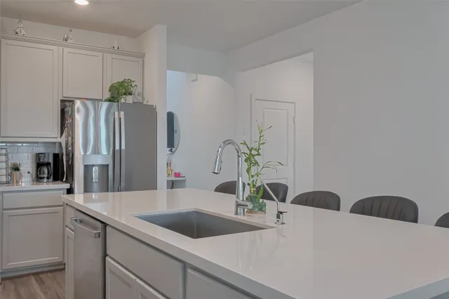 a close view of a sink and a refrigerator
