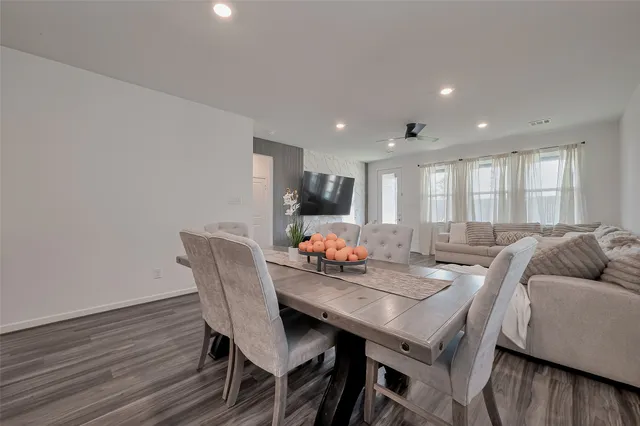 a view of a dining room with furniture and wooden floor