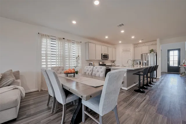 a view of a dining room with furniture and wooden floor
