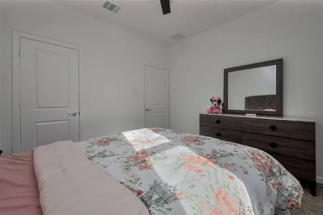 a bedroom with a bed and a dresser