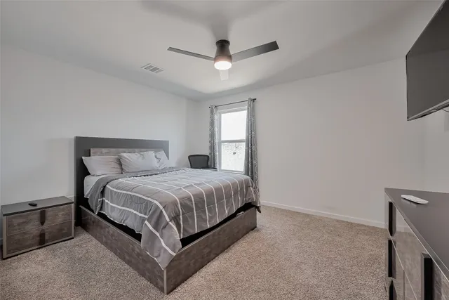 a bedroom with a bed and dresser