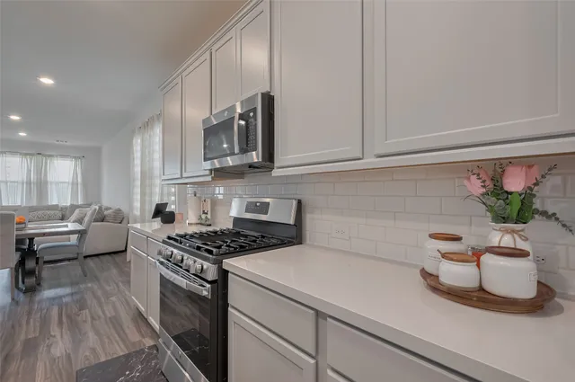 a kitchen with a sink a stove and cabinets