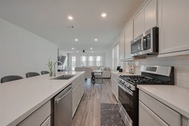 a kitchen with counter top space cabinets and stainless steel appliances