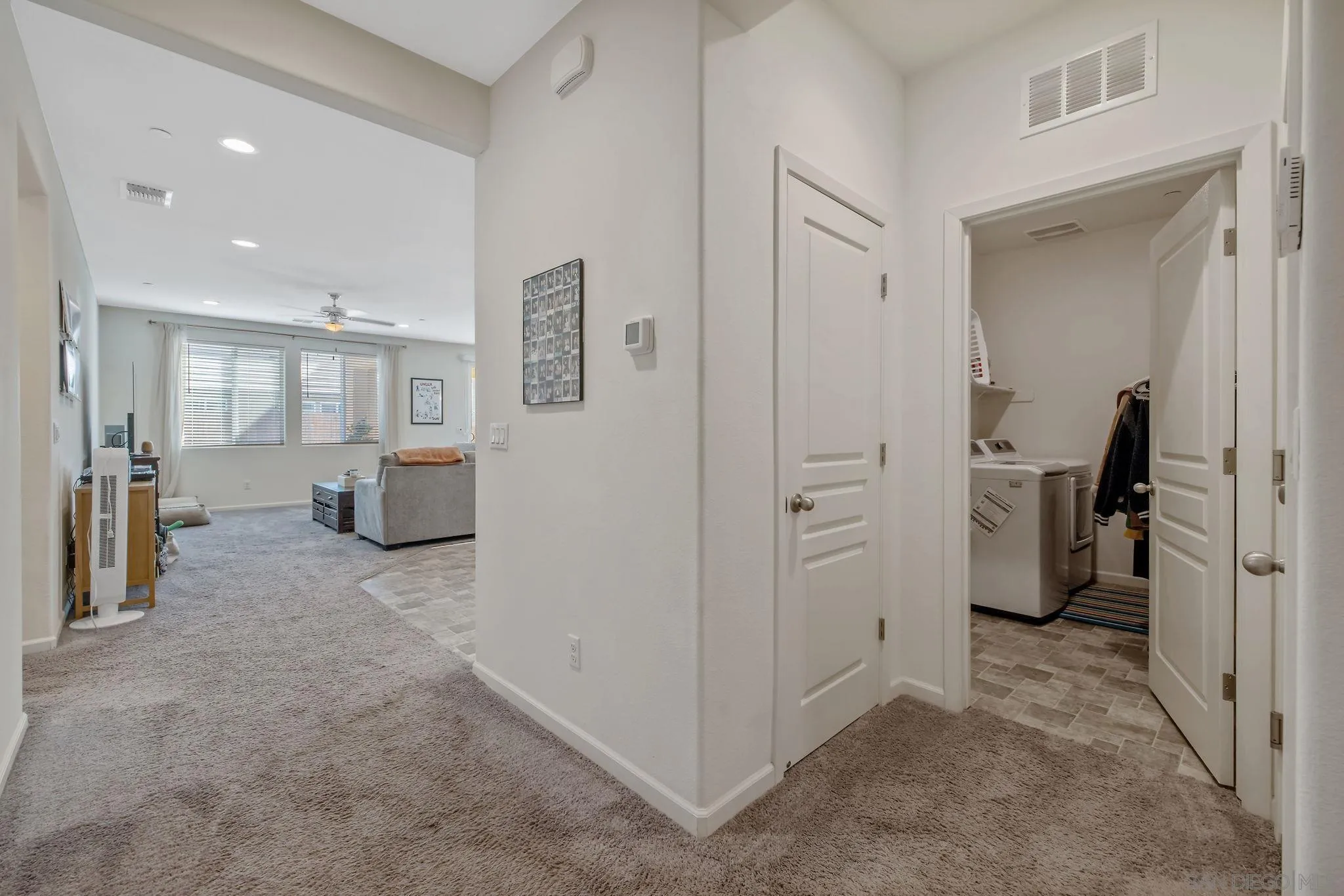 495 Pearl Drive Lemoore, CA 93245 - Photo 13 of 45 a view of a hallway with couch and a livingroom