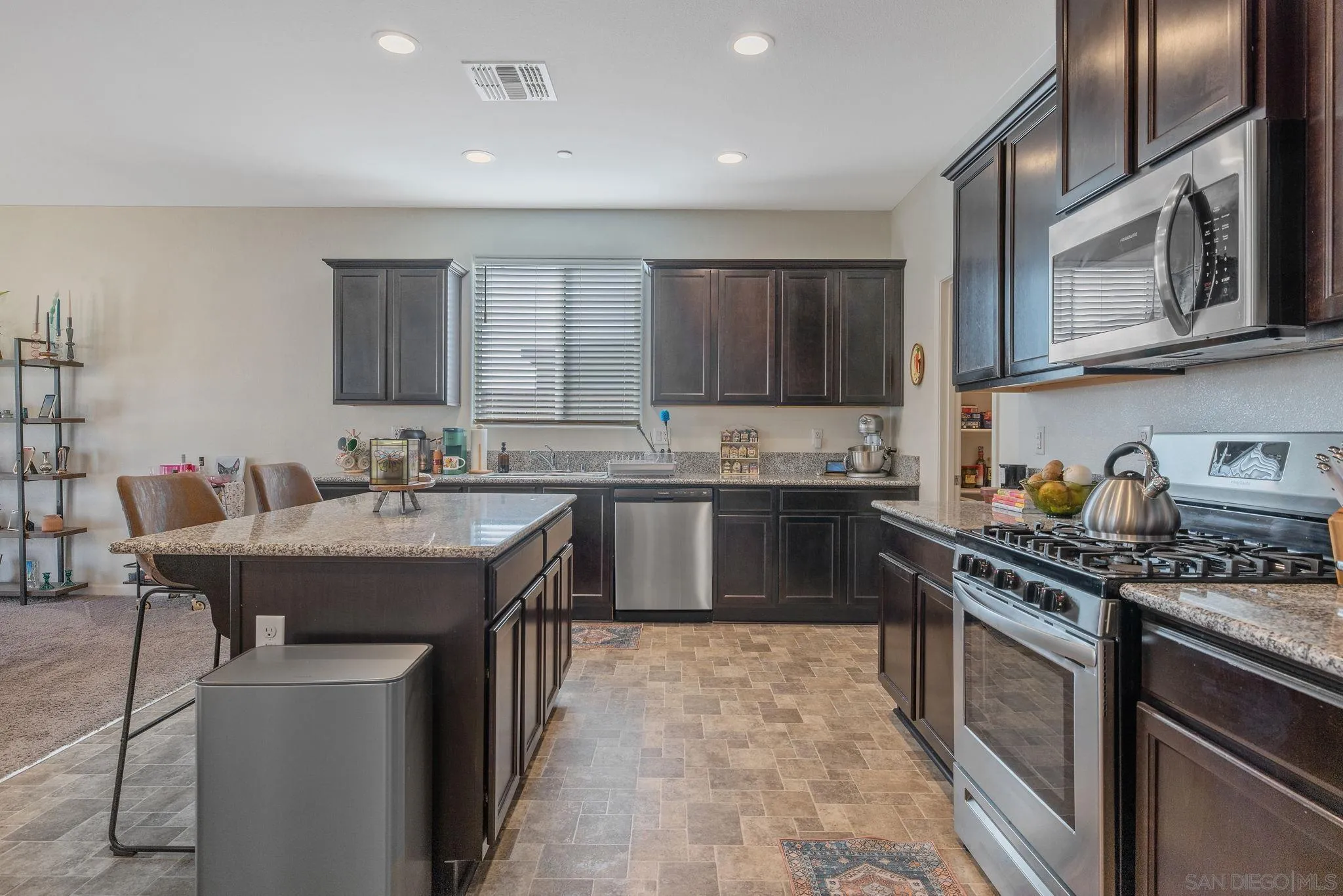495 Pearl Drive Lemoore, CA 93245 - Photo 18 of 45 a kitchen with stainless steel appliances granite countertop a sink stove and refrigerator