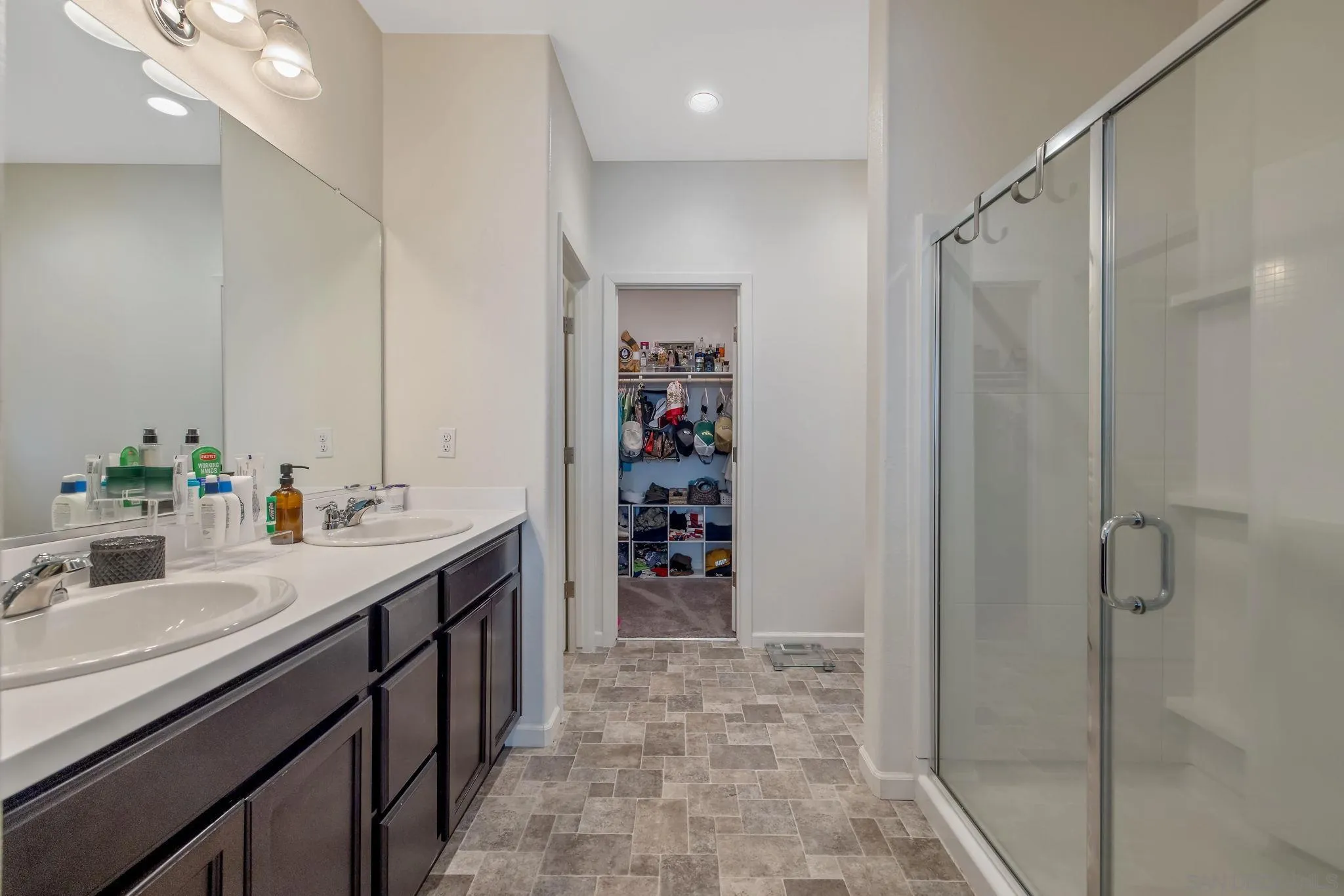 495 Pearl Drive Lemoore, CA 93245 - Photo 33 of 45 a bathroom with a double vanity sink a toilet and shower